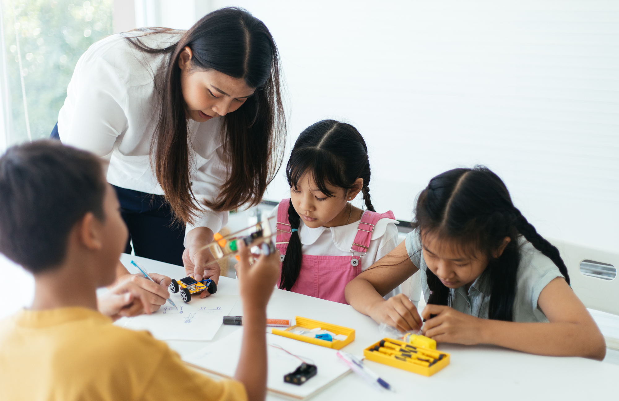 Photo of white man standing in front of a classroom whiteboard