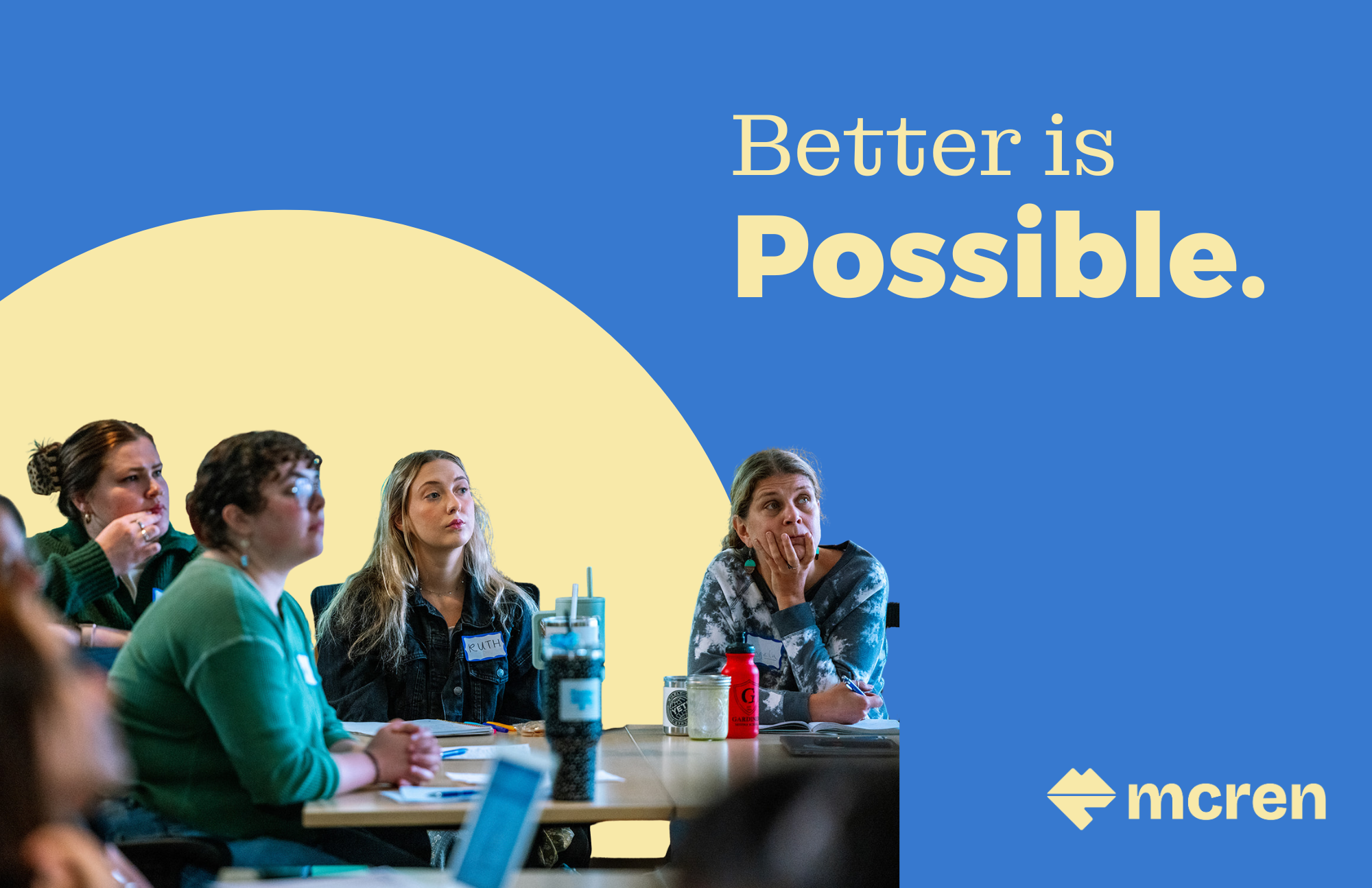 A woman with glasses and brown hair thinks with her hand on her chin.